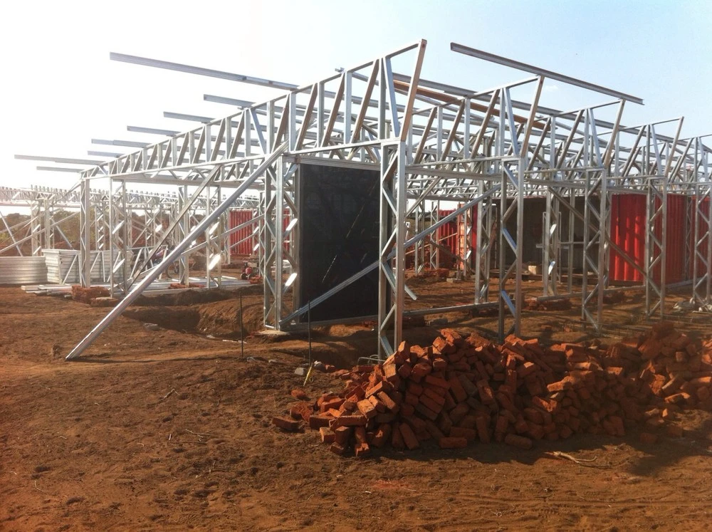 The containers were modified and a lightweight steel supporting frame and metal roof were added (Photo: Architecture for a change)