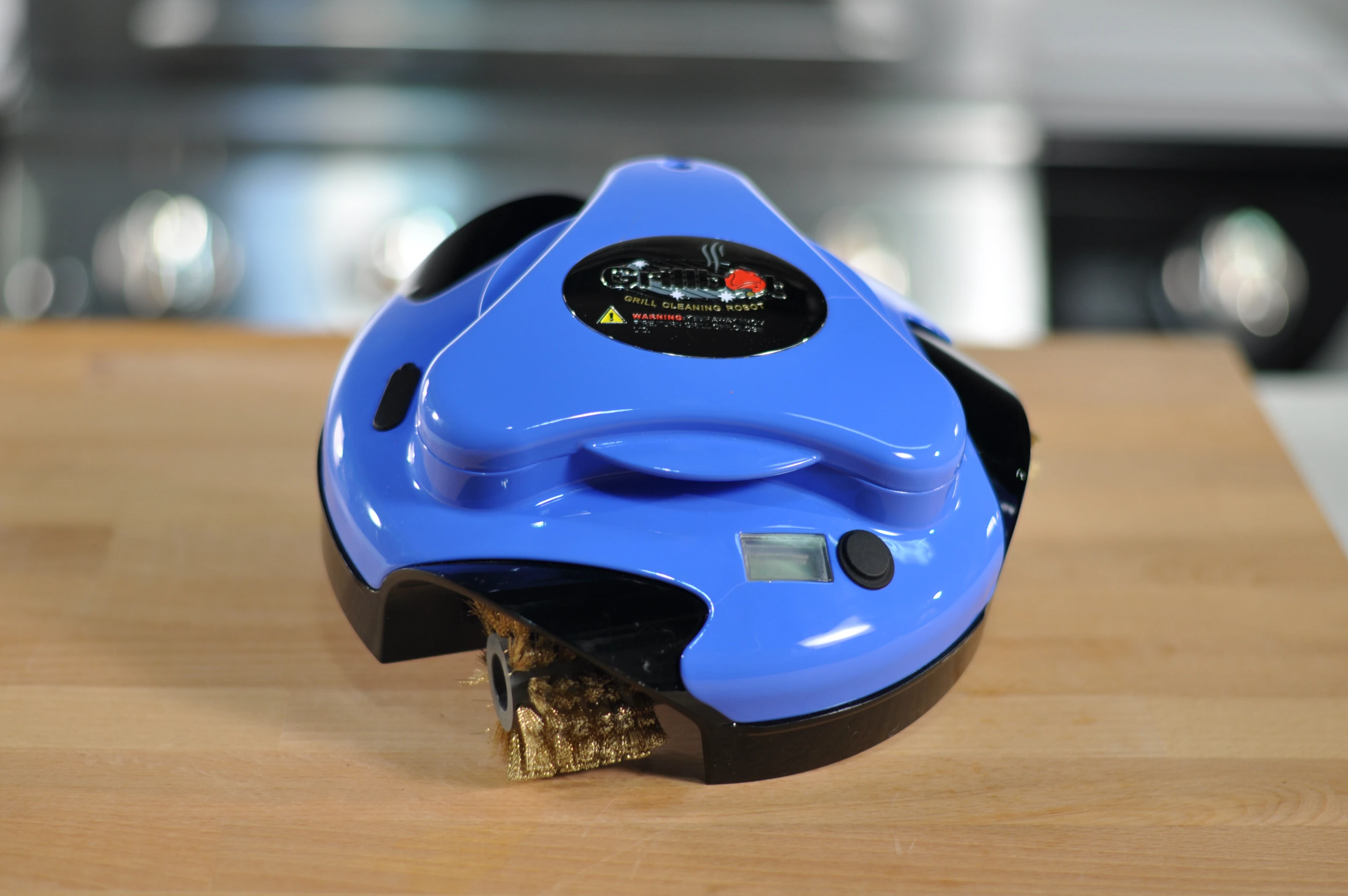 The Grillbot is a cute, single button operated bot that perches on your grill and lives to clean