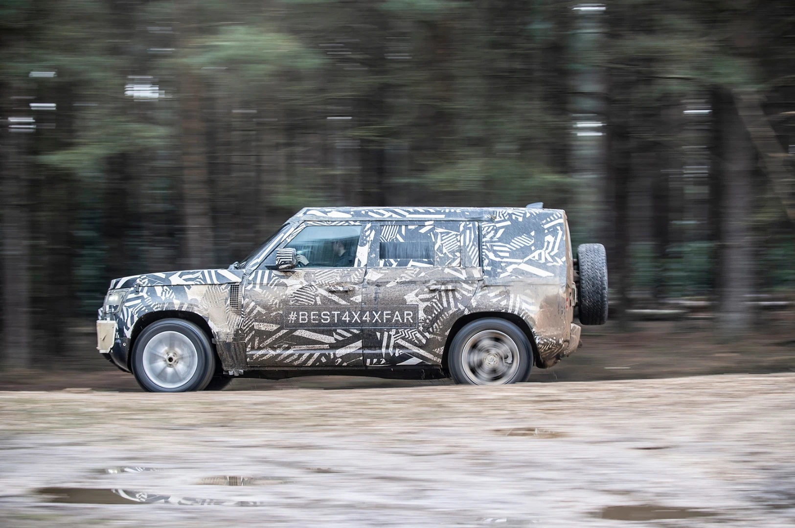 The prototype Land Rover Defender battling the mud of Eastnor, UK