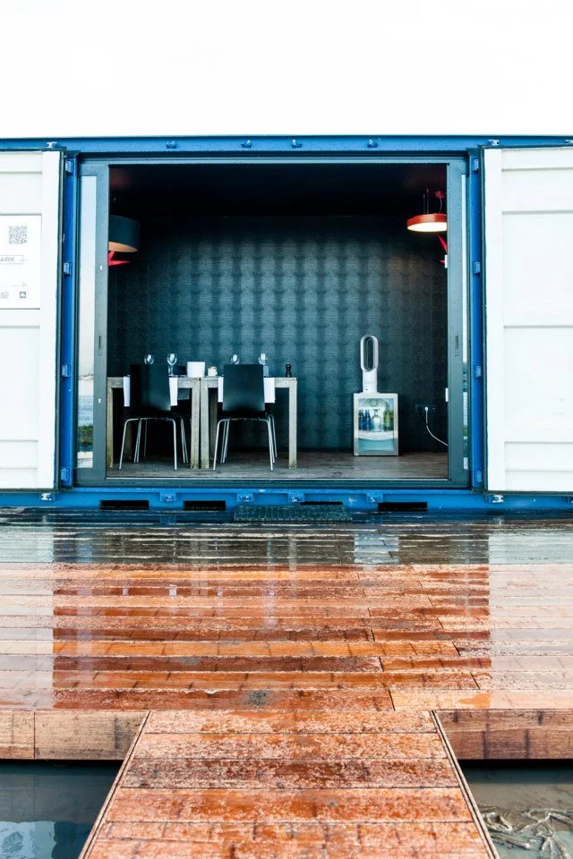 The lounge container is setup like a breakfast nook for guests to enjoy a cup of coffee or glass of wine together