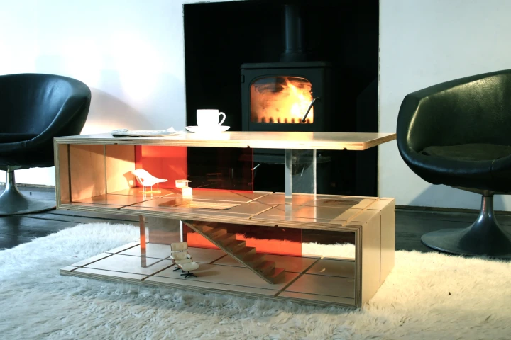 Sliding panels made from wood and perspex are slotted into grooves in the coffee table to make different room layouts