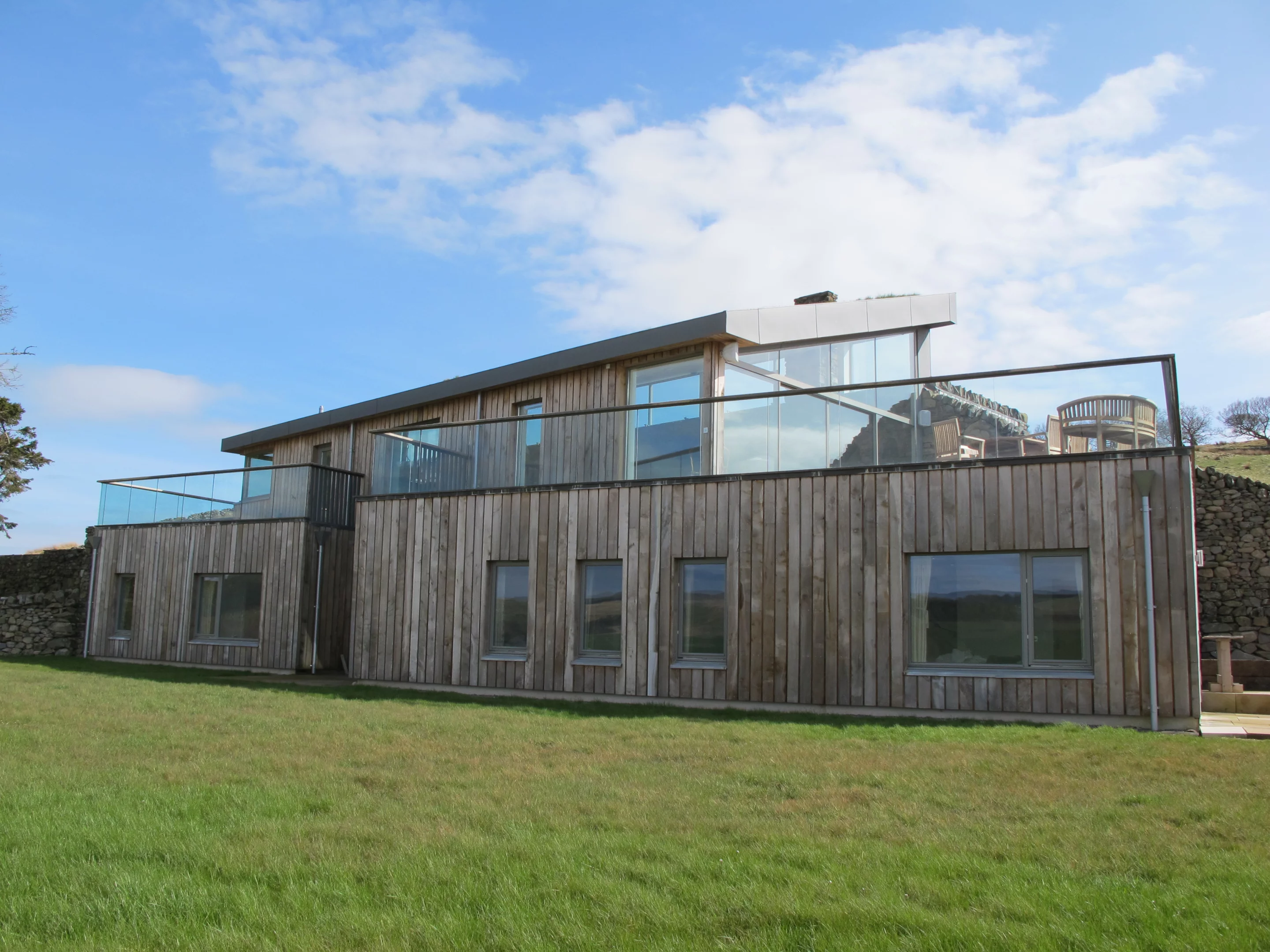 The building is clad with oak grown on the farm (Photo: Mark Waghorn Architects)