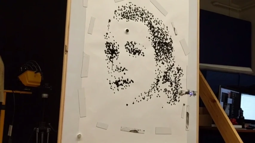 One of the quadcopters works on a portrait of Grace Kelly