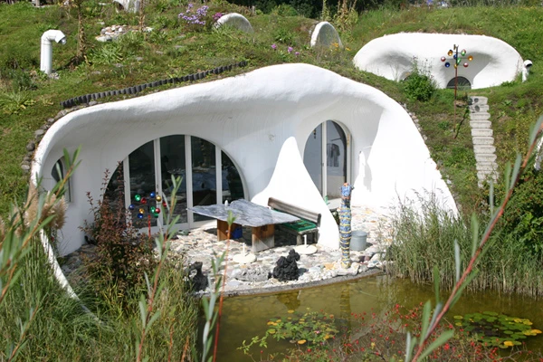 The Earth House Estate Lättenstrasse in Switzerland consists of several Hobbit Hole-style dwellings located around a wet courtyard