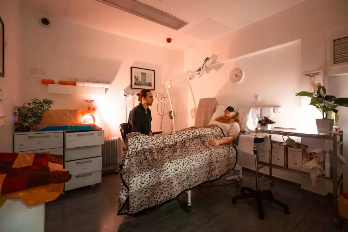 Lead researcher Christopher Timmermann overseeing a healthy volunteer in the treatment room where they are administered DMT and changes to brain activity observed