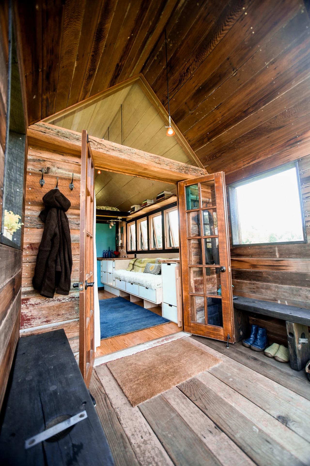 The small space features a light-filled living area with ample built-in storage cabinetry