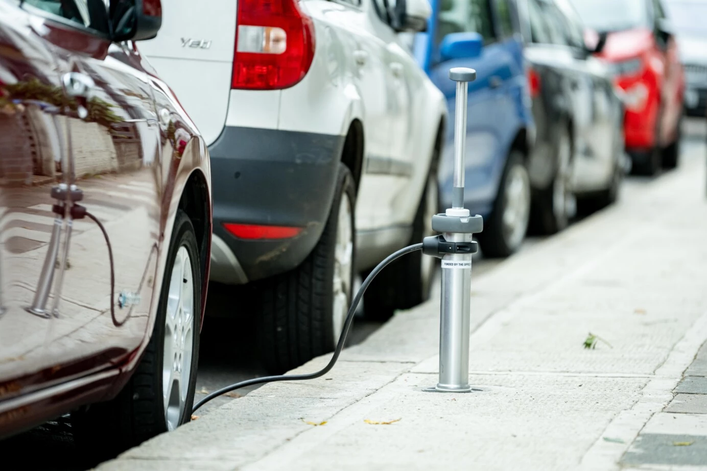 An array of 15 Trojan charge points installed along a street are connected to one 3-phase grid supply