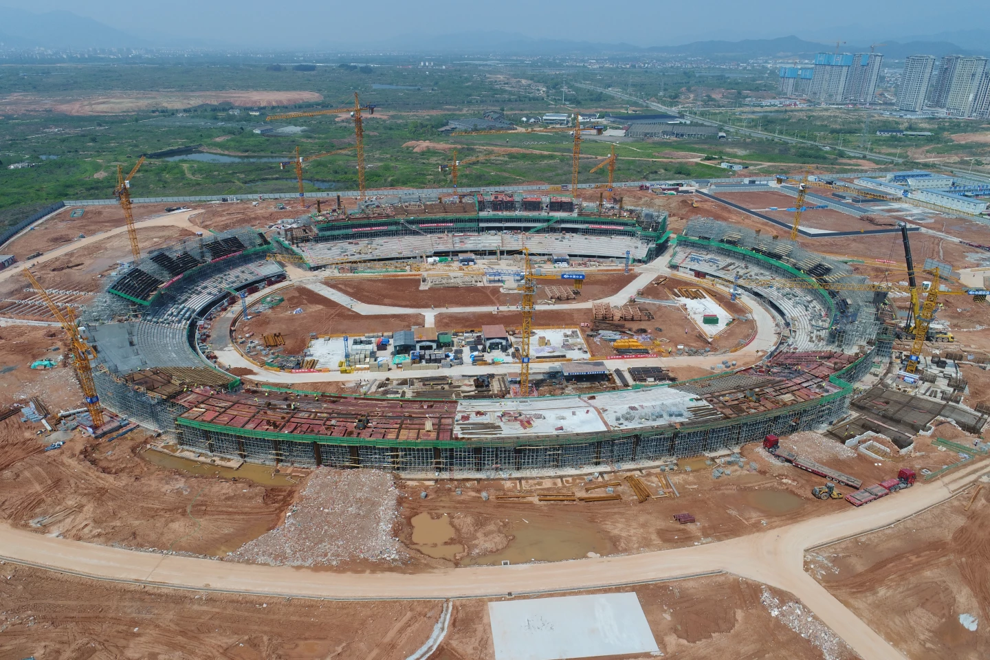 The Quzhou Sports Park's stadium will eventually blend into the landscape, though it's hard to imagine that from this photo ...