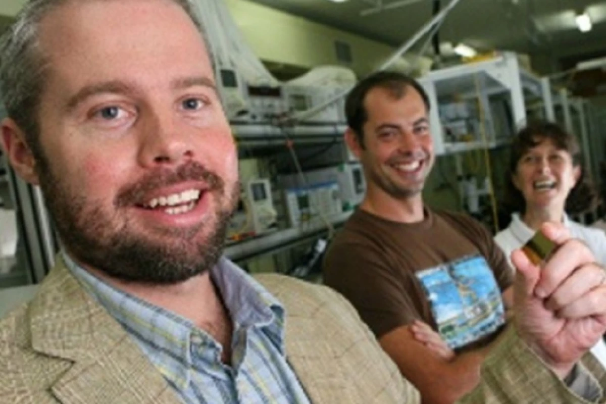 Professor Ben Eggleton (foreground) holding a photonic chip with (from left) student Neil Baker and researcher Snjezana Tomljenovic-Hanic(Photo: The University of Sydney)