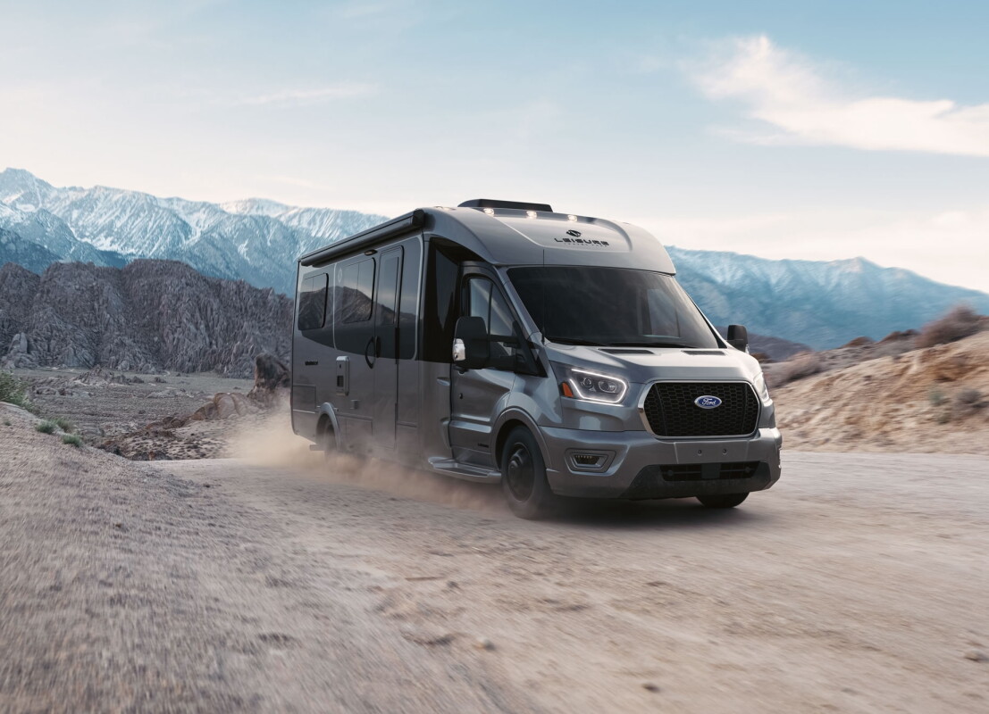 Ford minibus camper opens up via Murphy bed theater and corner office