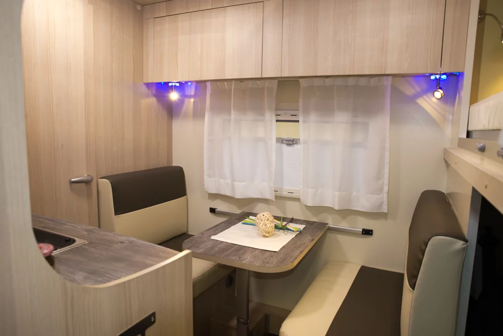 The dinette seats three on its two benches, leaving the driver cab seats to face forward all the time