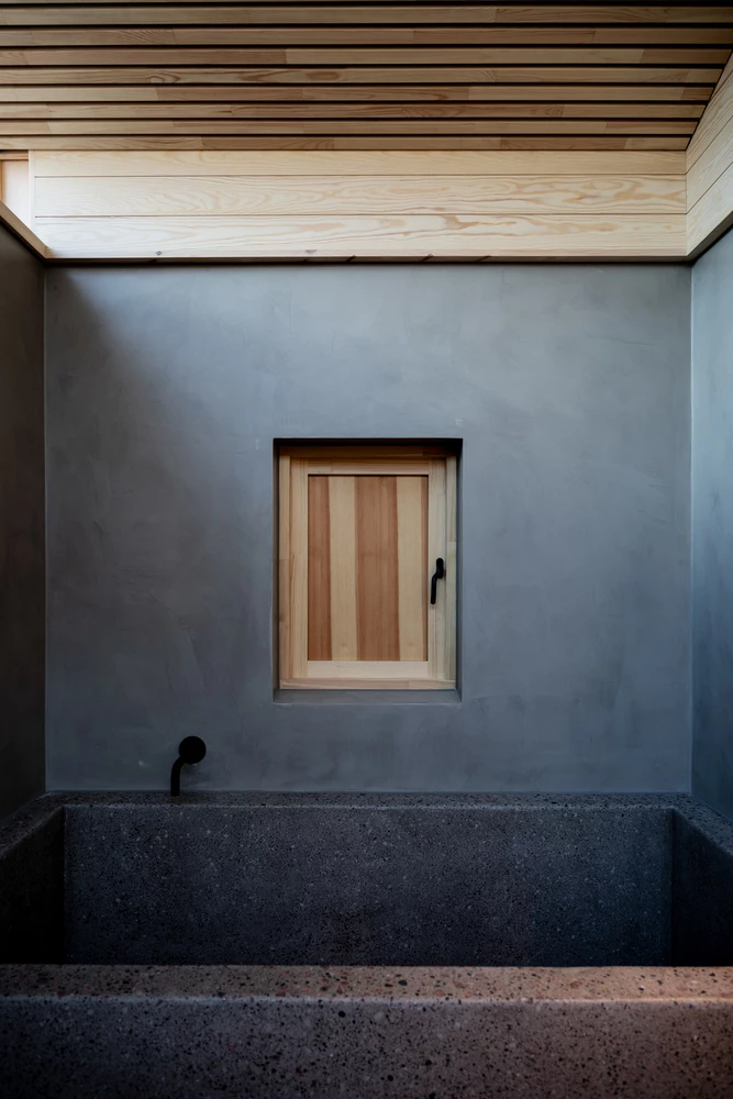 A serene bathroom sanctuary in soft grey tones, blending simplicity with calming elegance