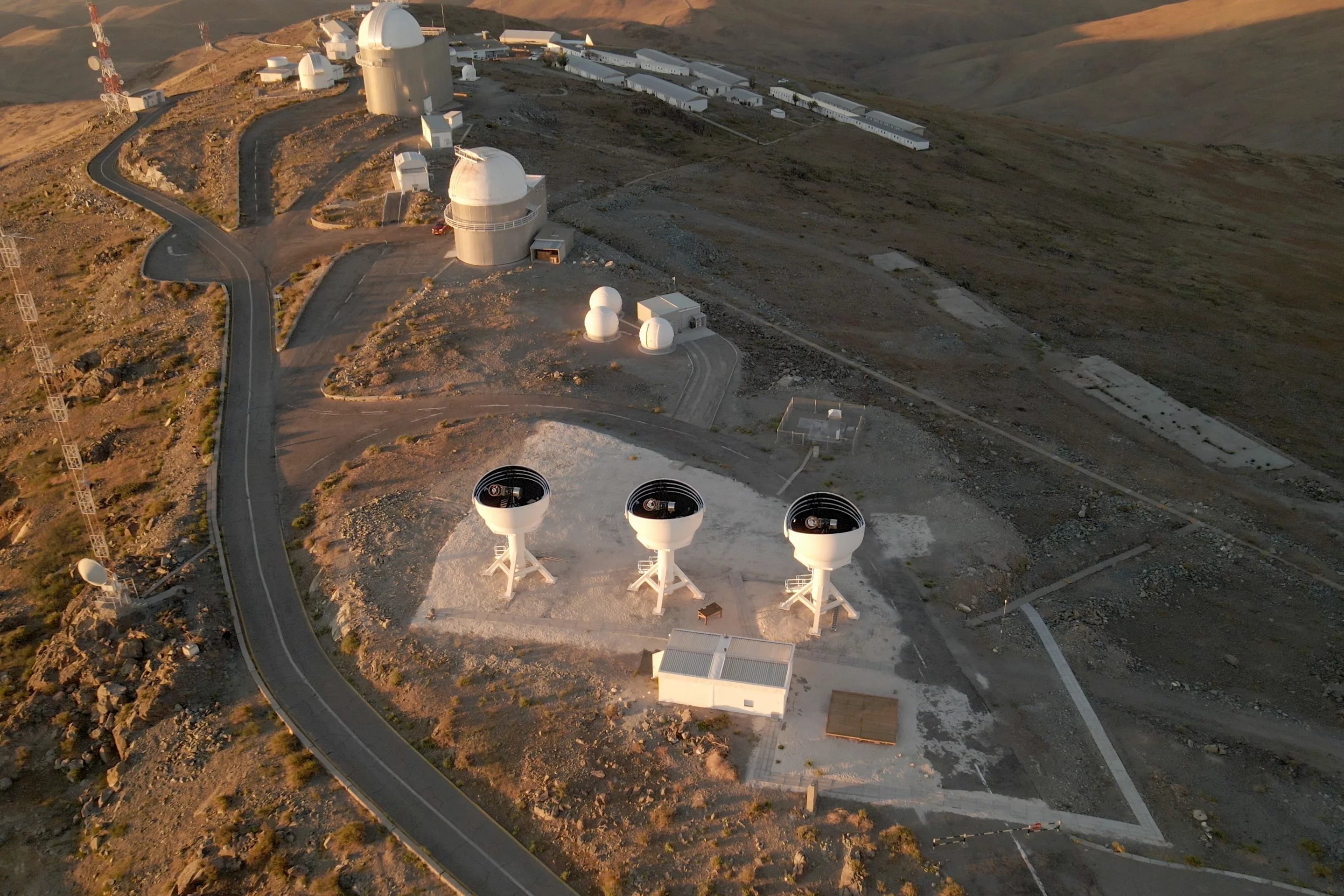 A drone shot of the BlackGEM array with its domes open, revealing the telescopes inside
