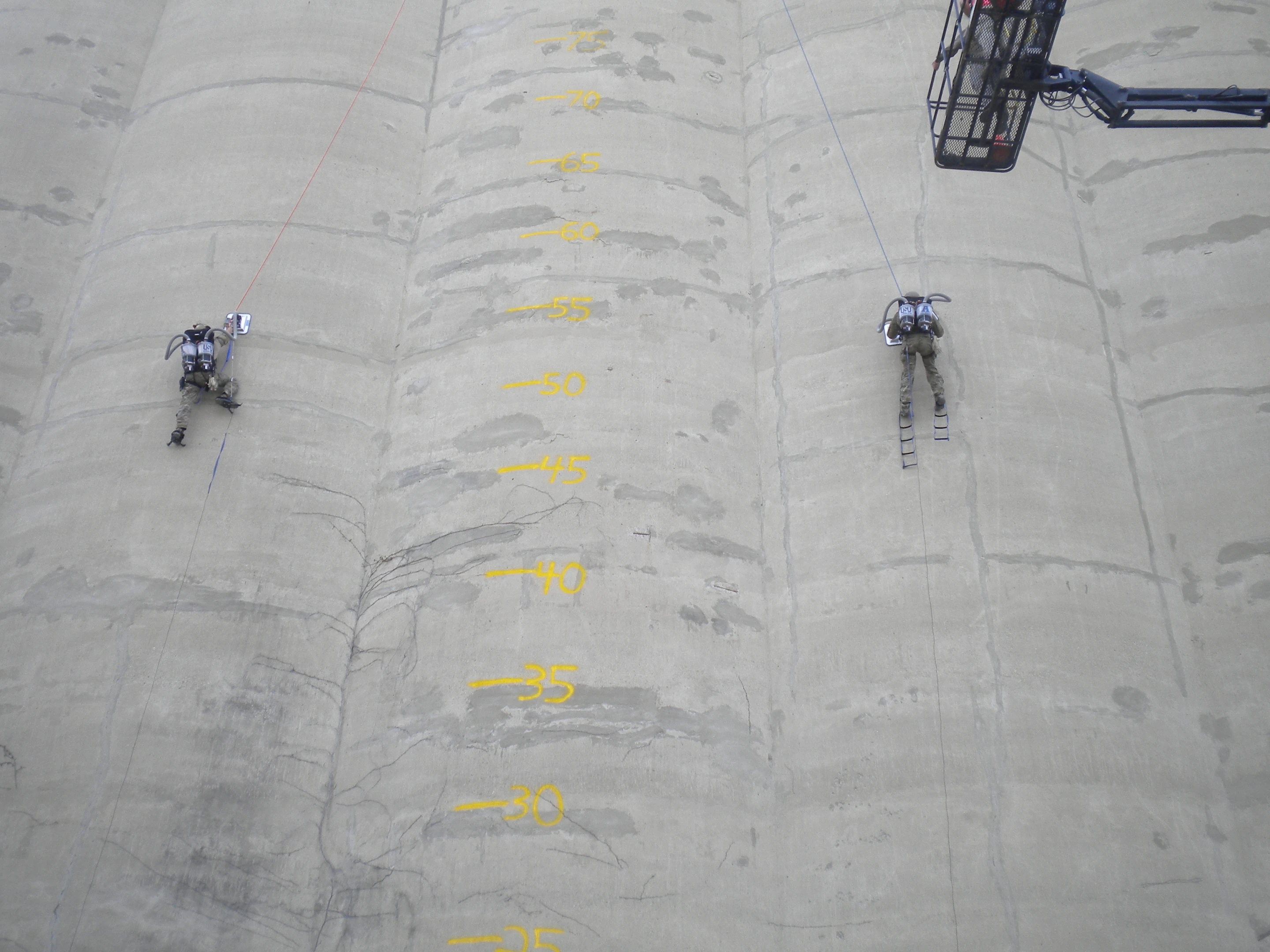 Two climbers ascend a silo, using Utah State University's PVAC system (Photo: USU)