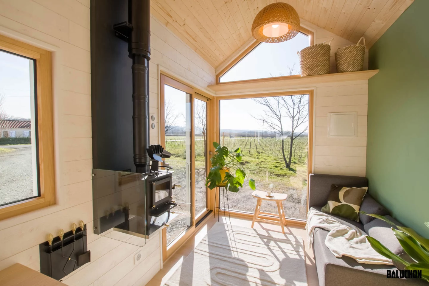 Visitors to the Bois Perdus enter into its light-filled living room, which includes a sofa and a small storage loft area