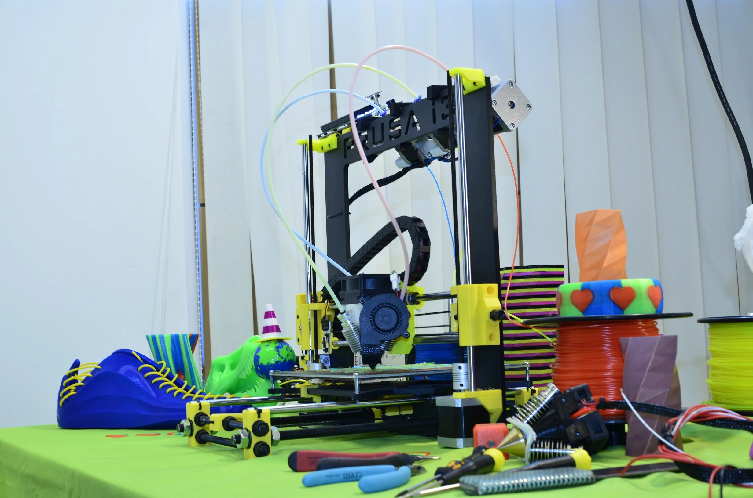 RepRap.me's Diamond Hotend on a Prusa 3D printer, surrounded by some of its handywork