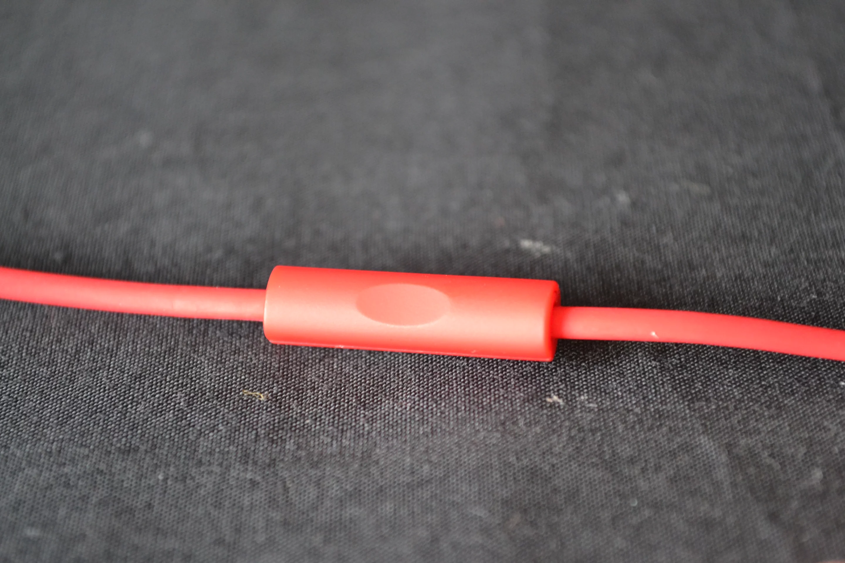 The front of the playback control positioned midway between the Y junction and the right earpiece