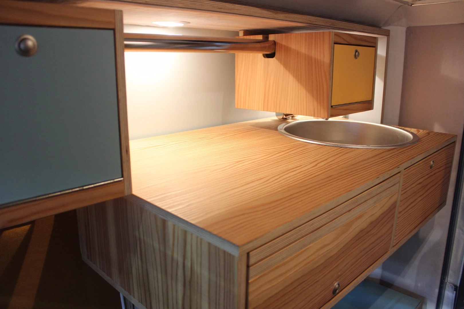 The kitchen lifts up out of the way to provide room to lie down on the bed below