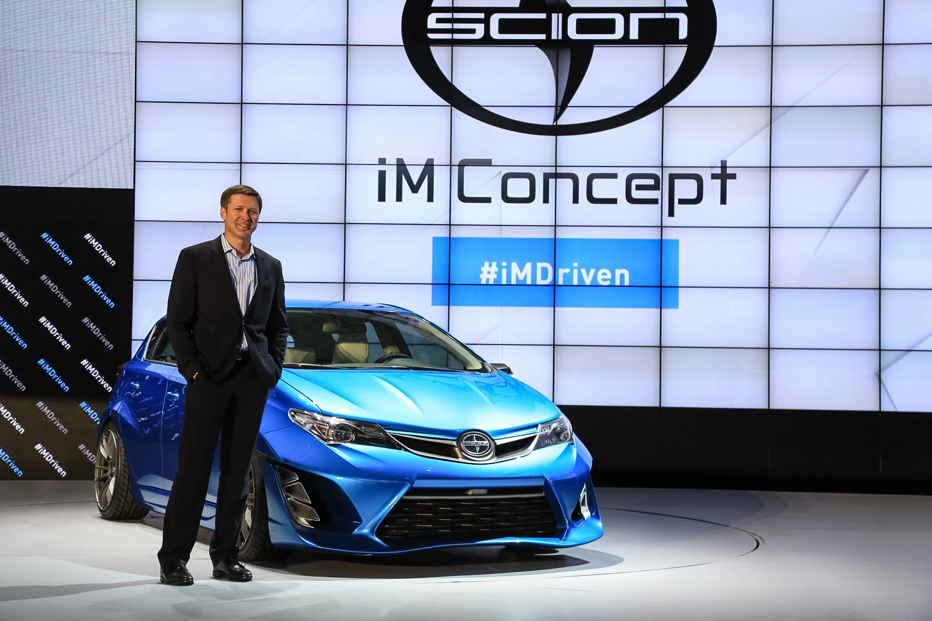 Scion Vice President Doug Murtha stands with the Scion iM concept at the LA Auto show