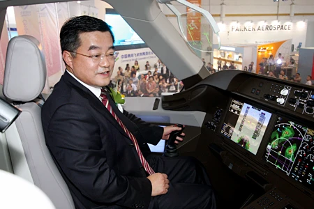 COMAC chairman and party secretary Zhang Qingwei checks out the C919 prototype cockpit