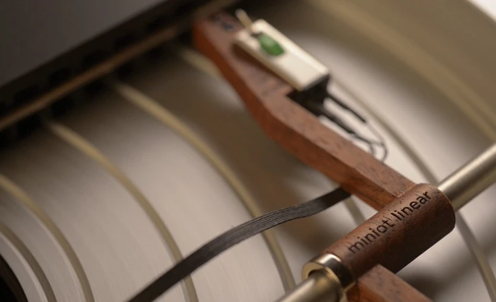 The Wheel's tonearm is made from a single piece of machined mahogany laminate, ending in a modified AT95E cartridge