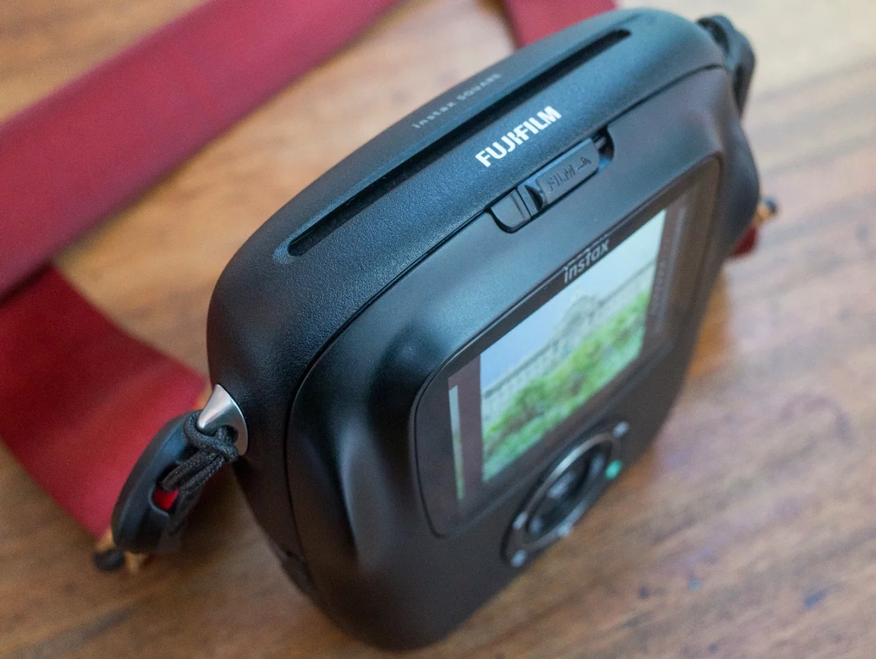 The slot on the top of the Fujifilm Instax SQ10 is where prints emerge from