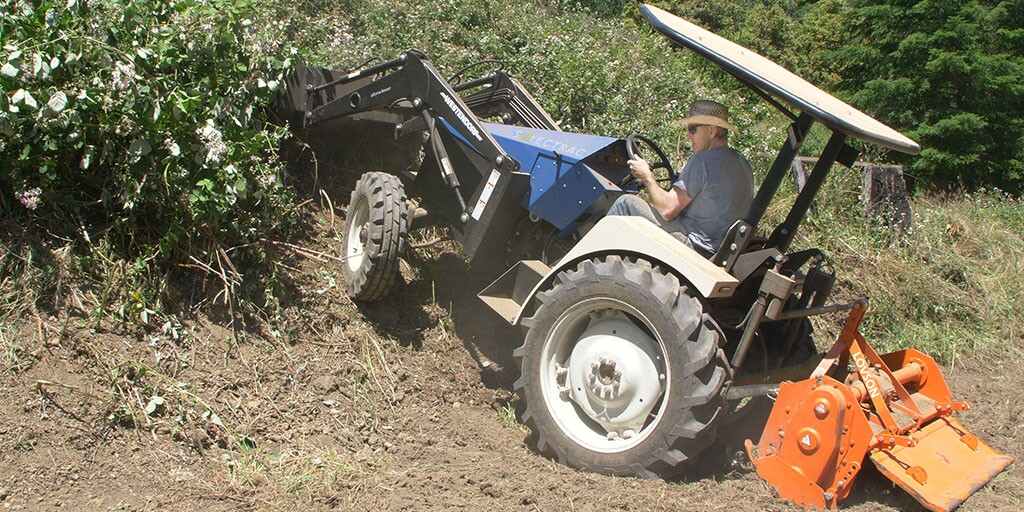 The eUtility Electric Tractor, seen here with its front loader