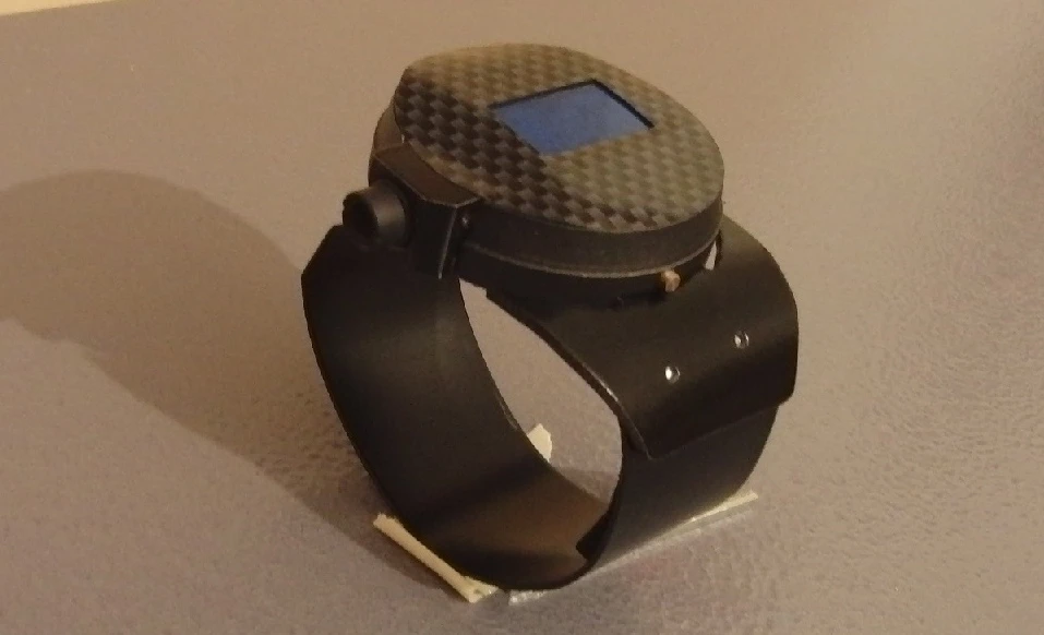 The watch features a machined metal body, a clear-coated carbon fiber face, a salvaged LED watch module and most notably, a 1,500-milliwatt laser module