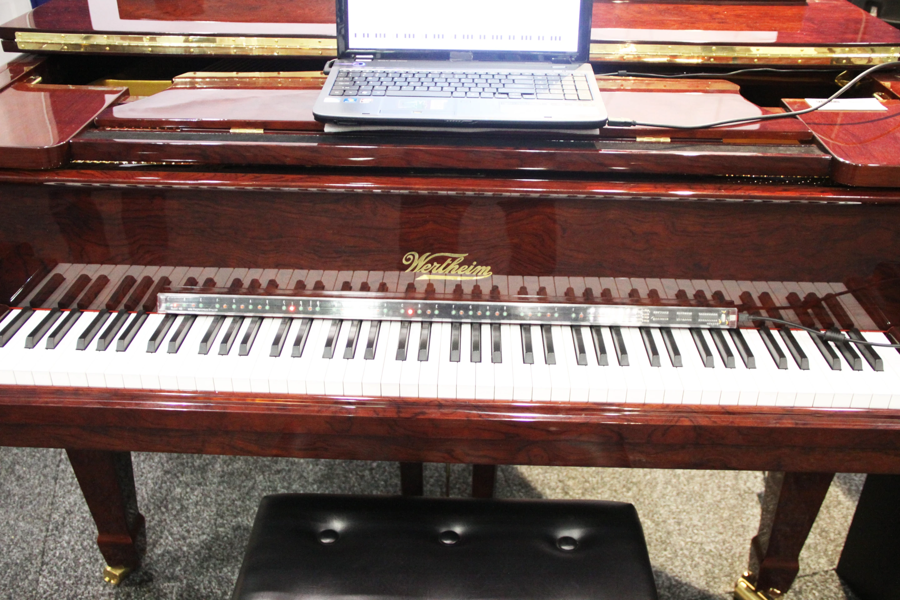 The PianoMaestro learning system on a grand piano