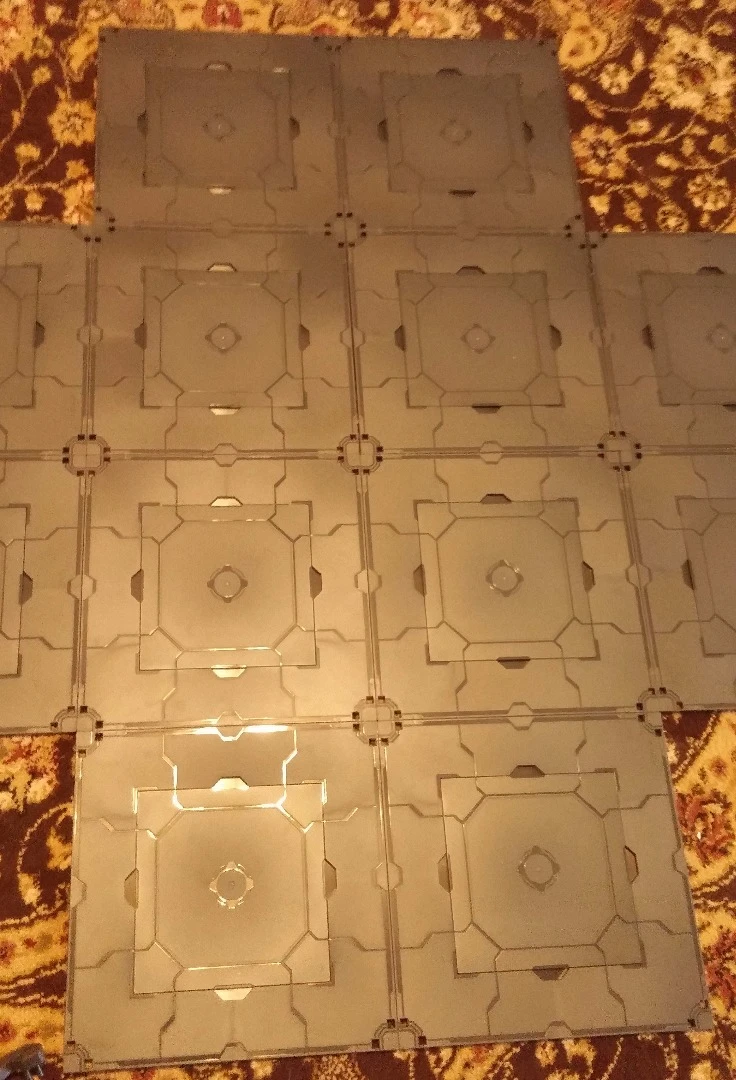 Building a battle arena begins with the layout of the tiles, which connect through magnets set in their sides