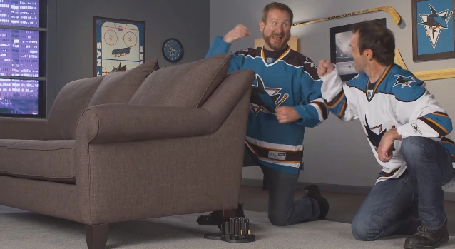 Gleeful Sharks fans install the Buttkicker Advance unit under their couch