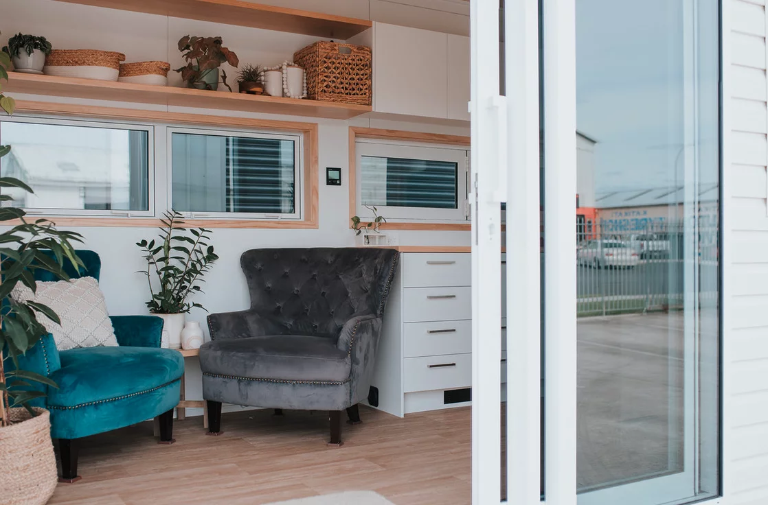 Visitors enter the Kōtuku into the living room, which looks light-filled thanks to its generous glazing