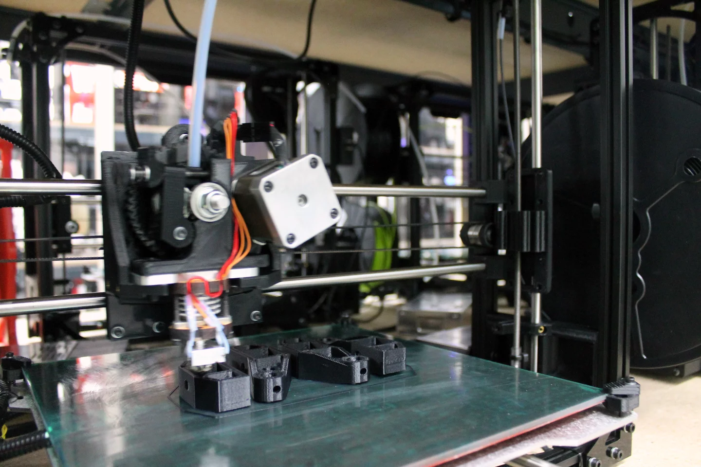 A Lulzbot TAZ 3 zips away at Y-corner parts which will later serve as the feet holding up the Y-axis of a future printer