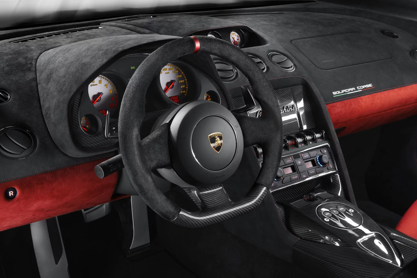 Alcantara and carbon fiber mix beautifully throughout the Squadra Corse's interior