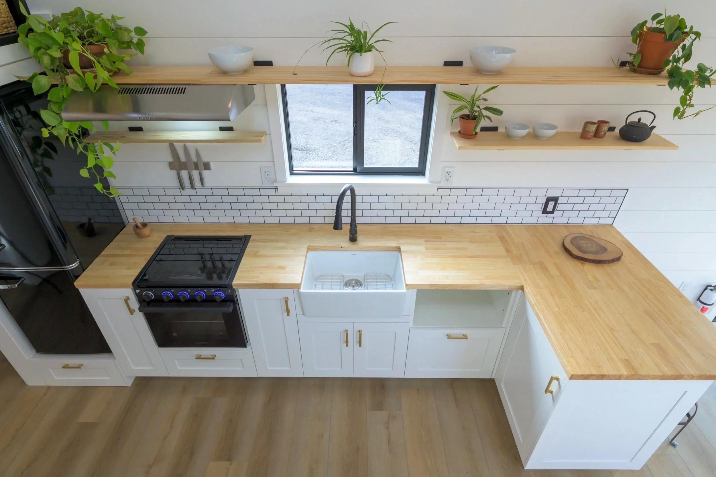 The Ochoco's kitchen includes a fridge/freezer, oven and cooktop, a farmhouse-style sink, and space for more appliances