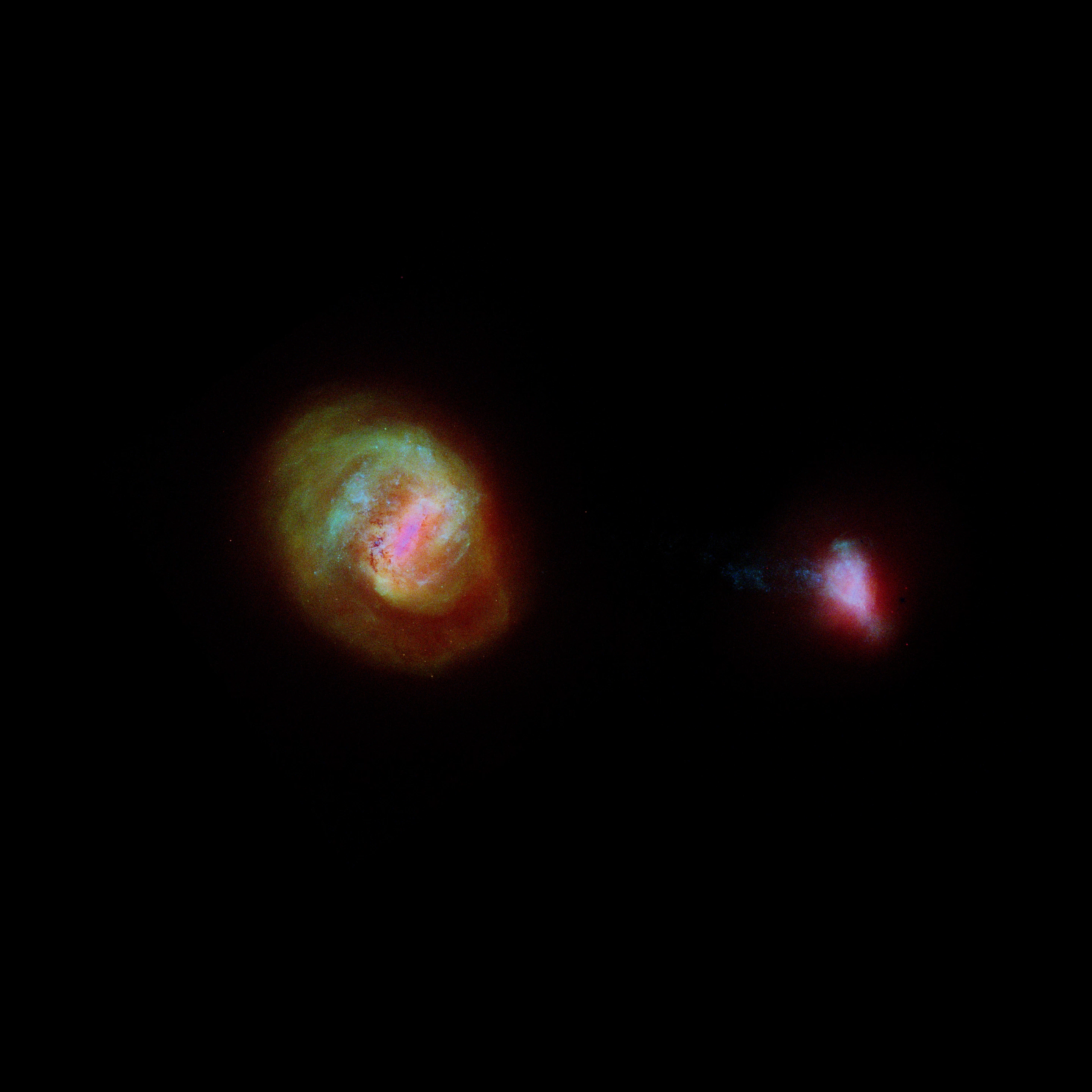 An image showing the stellar densities of the large and small magellanic clouds. The color red indicates the presence of older stars, green intermediate, and blue the most youthful stellar bodies.