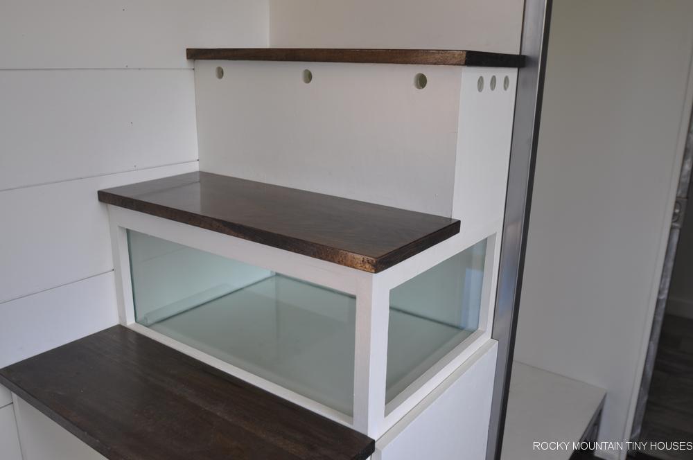 The Ad Astra's staircase has an integrated gecko vivarium and a cat litter tray