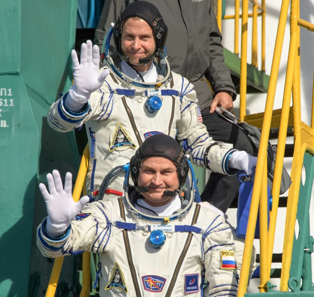 Expedition 57 Flight Engineer Alexey Ovchinin of Roscosmos, left, and Flight Engineer Nick Hague of NASA boarding their spacecraft