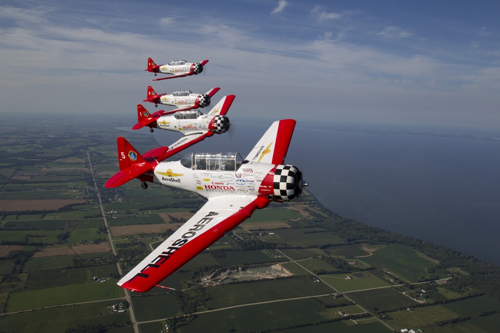 The AeroShell team in formation over Oshkosh (EAA photo/Amy Gesch)