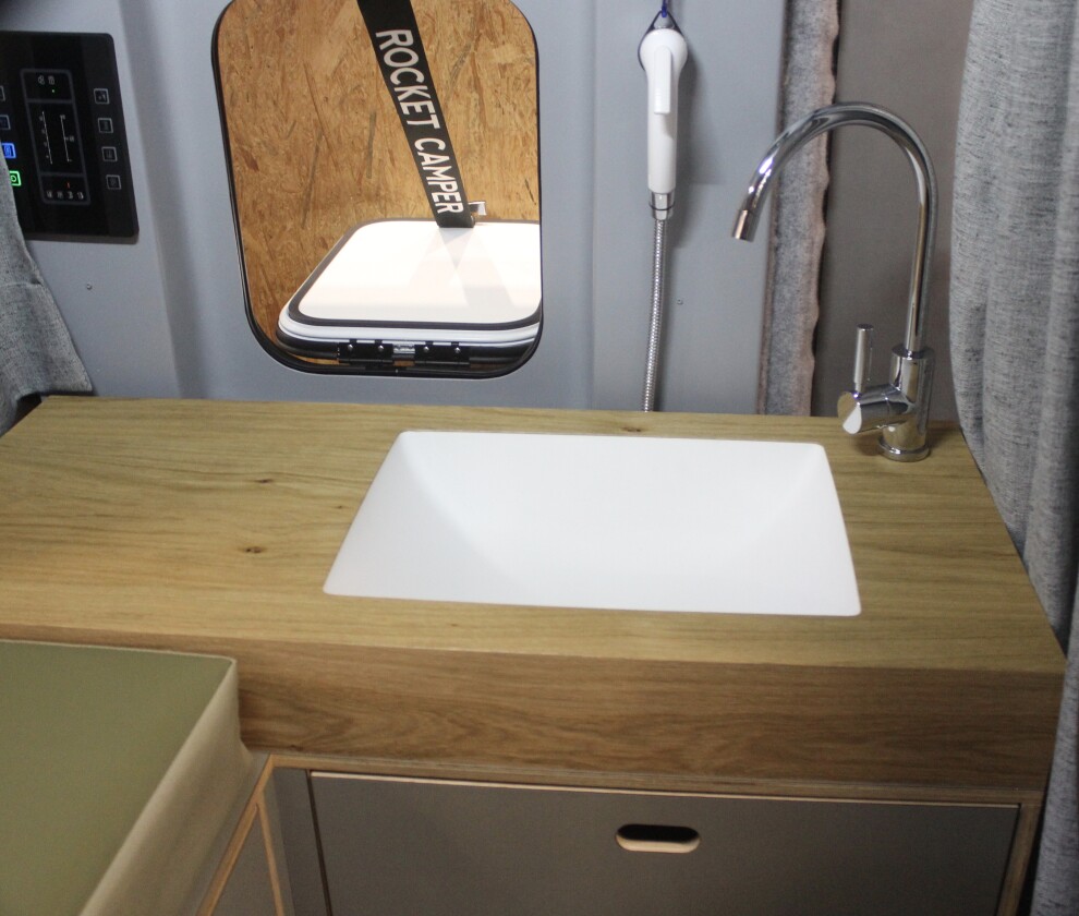 Perhaps the most interesting part of the build, the deconstructed bathroom combines a sink, slide-out portable toilet, outdoor shower and personal organizer