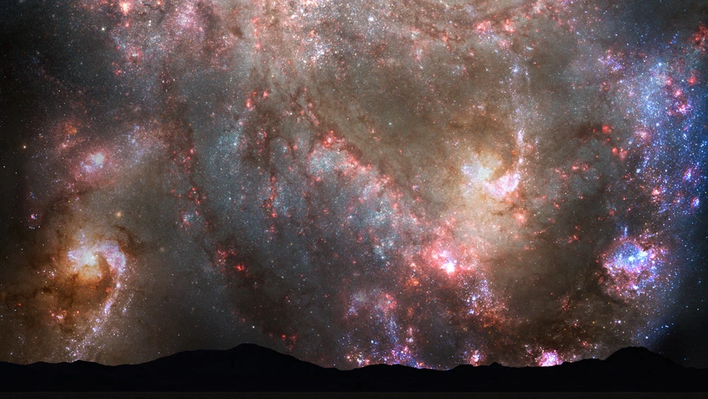 During the first close approach just prior to four billion years in the future, the sky is ablaze with new star formation, which is evident in vast numbers of emission nebulae and open young star clusters (Image: NASA / STScI)
