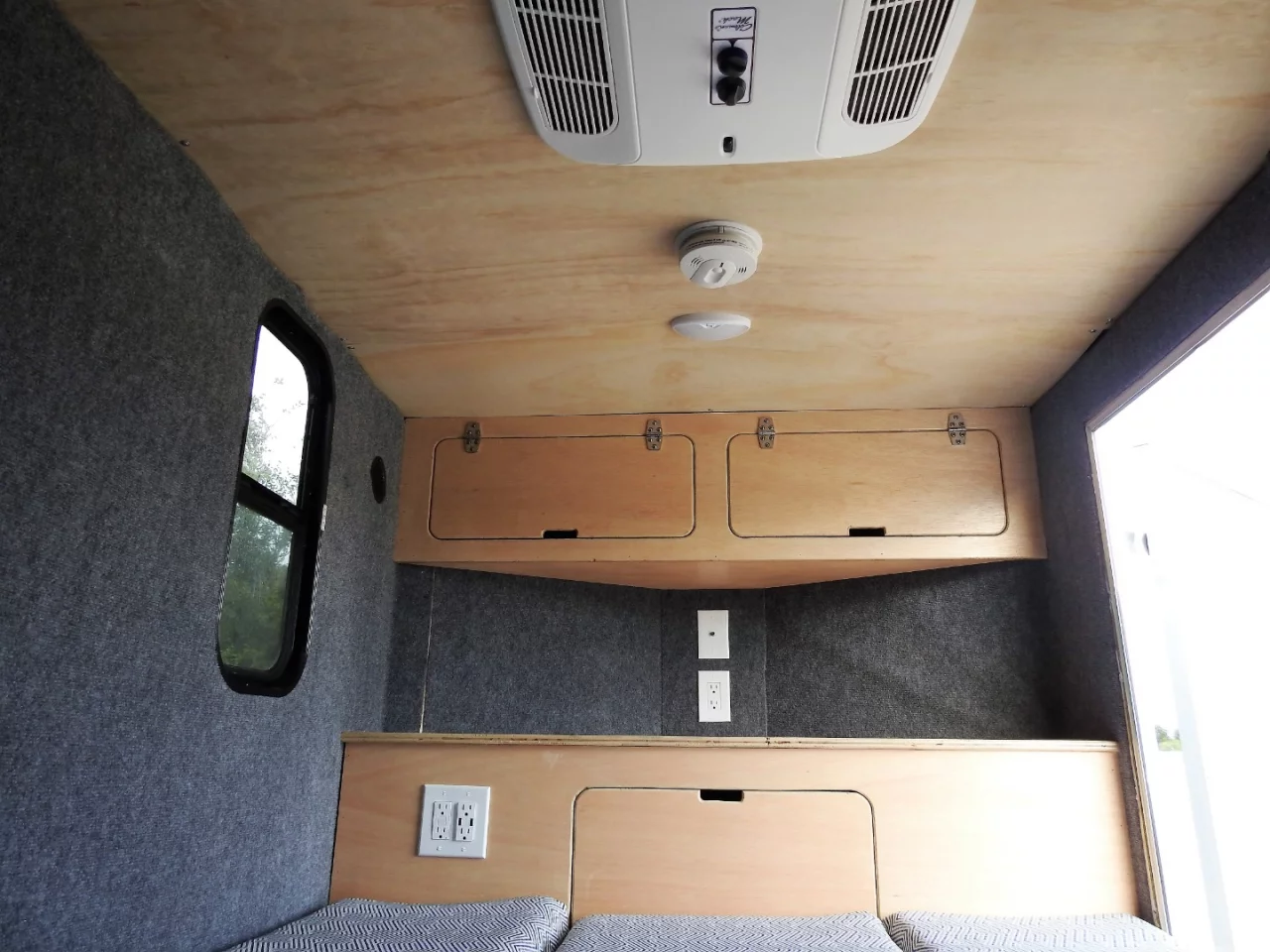 While the Cargo Camp is a very simple, affordable design, free of bells and whistles, that front cabinetry certainly looks perfect for housing a TV, maybe a full entertainment center