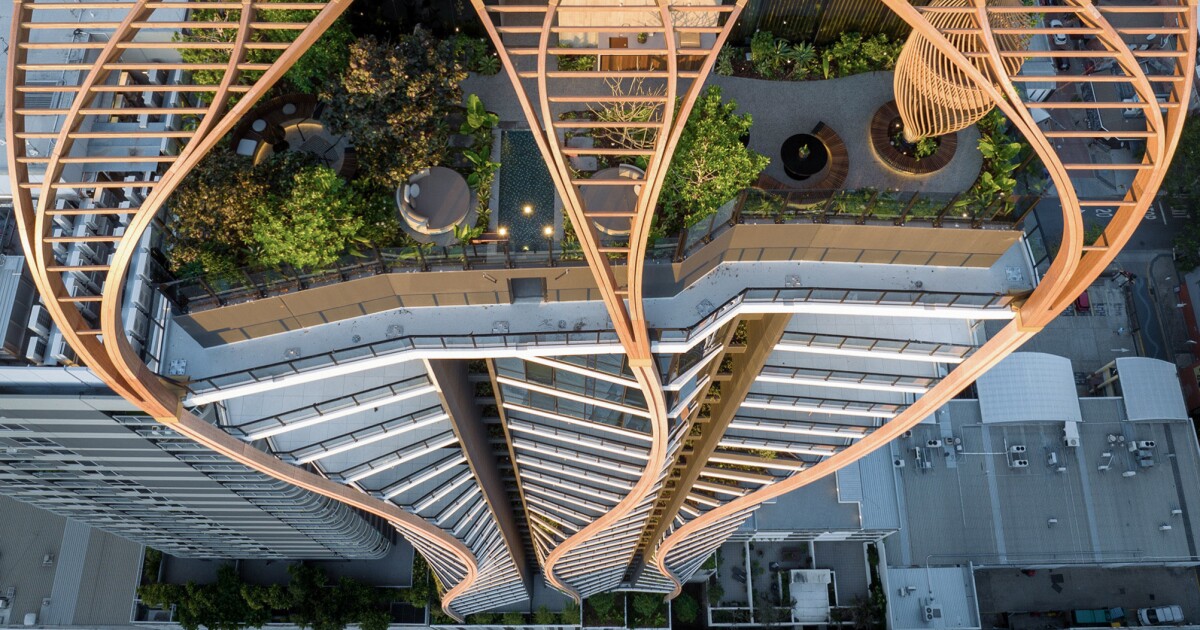 Timber-fronted twisting tower embraces indigenous roots Timber-fronted twisting tower embraces indigenous roots