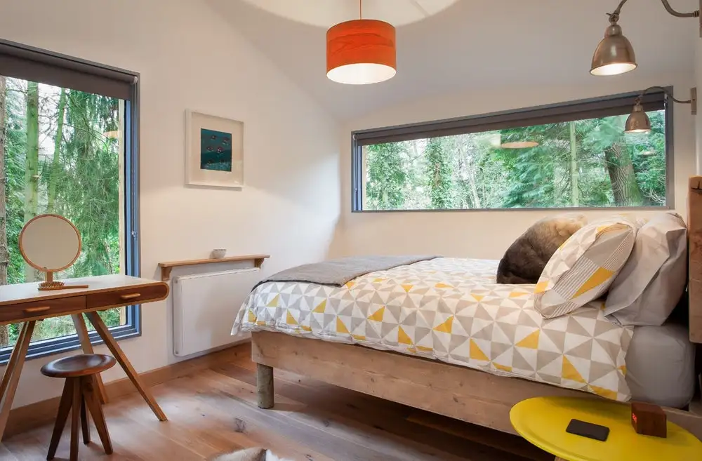inside the Bird house in Somerset, England, a solar-powered treehouse-style dwelling supported by sections of tree trunk stilts and accessed via wooden steps
