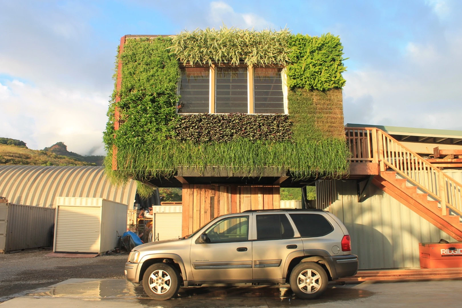 The greenery-covered dwelling boasts optional solar panels and a rainwater collection system