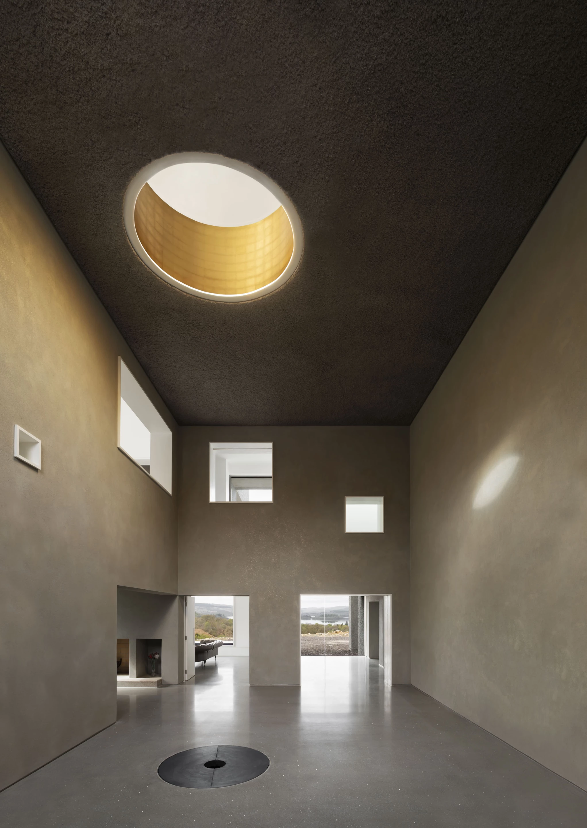 Hundred Acre Wood is finished in cladding that was created using crushed and recycled TV screens, while its interior design focuses on natural light