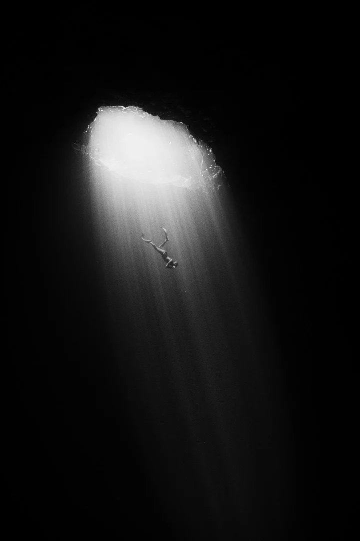 Freediving instructor Julien Borde descending into a Cenote in the Yucatan Peninsula, Mexico