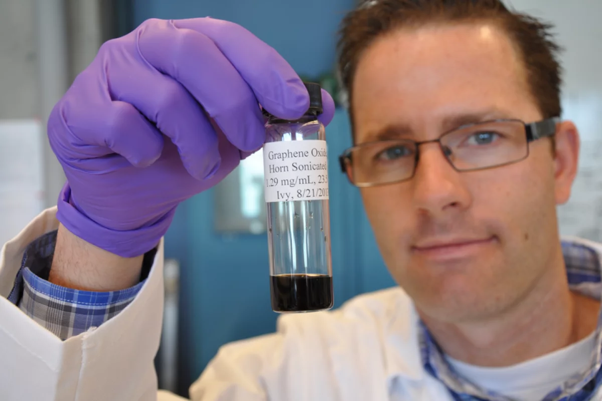 Jacob D Lanphere, a Ph.D. student at UC Riverside, holds a sample of graphene oxide
