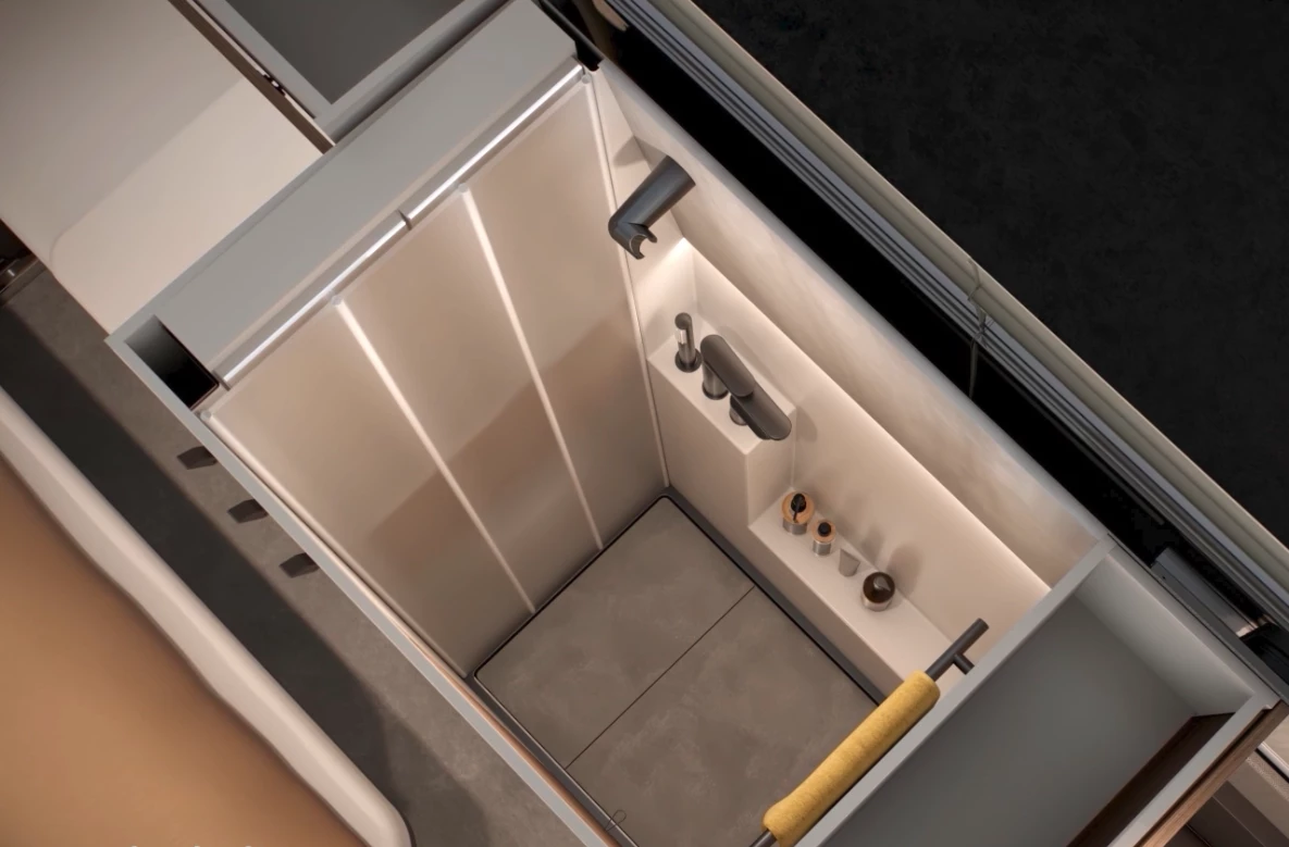 For showers, the toilet and sink basin retract away and an accordion wall folds over to create a dedicated shower space