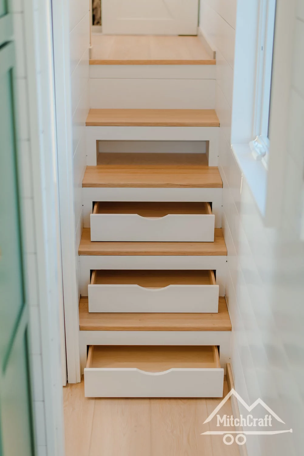 Storage-integrated stairs leading to the master bedroom